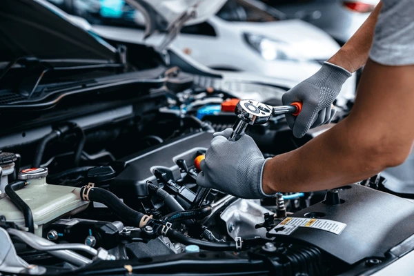 mechanic-using-wrench-while-working-600nw-2184125681
